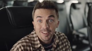 Frankie Muniz sitting in an airplane starring in a commercial for Spirit Airlines