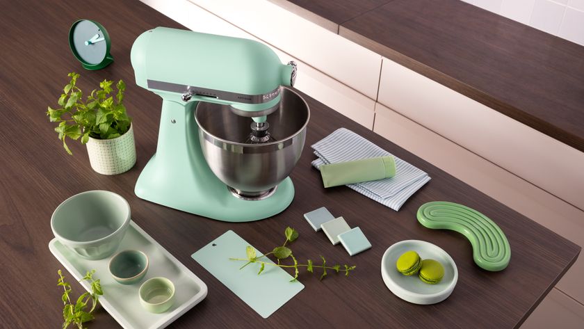 KitchenAid stand mixer in spearmint with an assortment of green foods and kitchen accessories on countertop