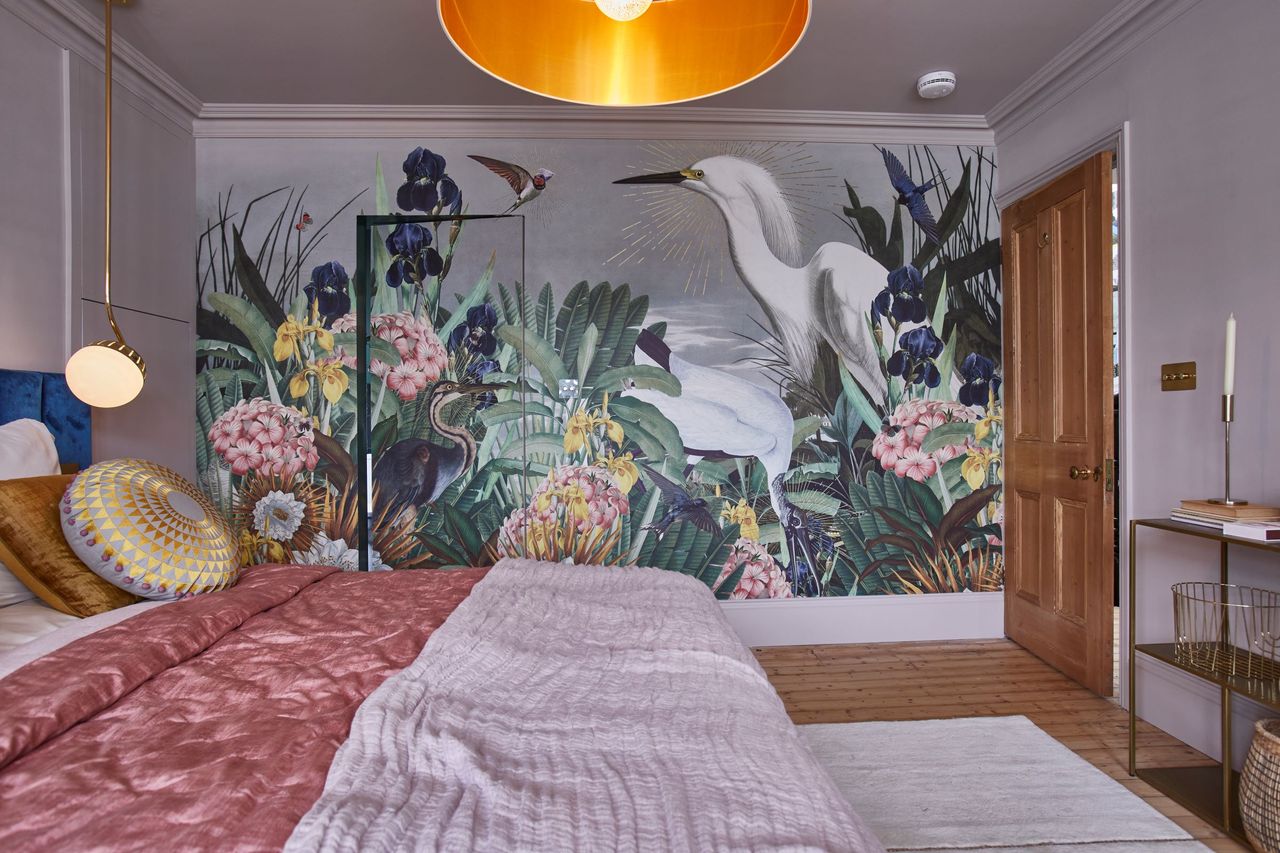 The bottom floor bedroom includes a mural on the wall of two peacocks in a swamp