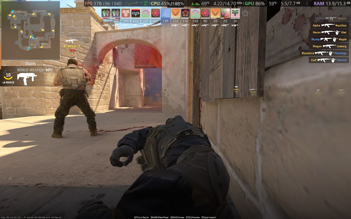 Counter-Strike 2 gameplay screenshot showing gunfights and UI elements running on an Alienware 15 laptop