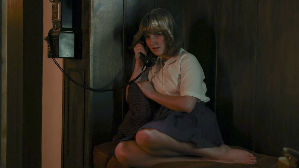 Mckenna Grace as Jan Broberg on the phone in A Friend of the Family