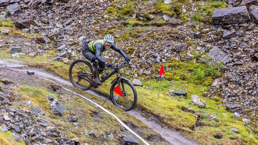 rider riding through red flags at the Ard Rock Enduro