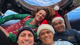 Expedition 68 Flight Engineers (from left) Josh Cassada, Nicole Mann, and Frank Rubio, all from NASA, and Koichi Wakata of the Japan Aerospace Exploration Agency (JAXA), pose for a festive portrait on Christmas Day inside the cupola as the International Space Station orbited 270 miles above the southern Atlantic Ocean.