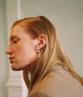 woman wearing Completedworks earrings