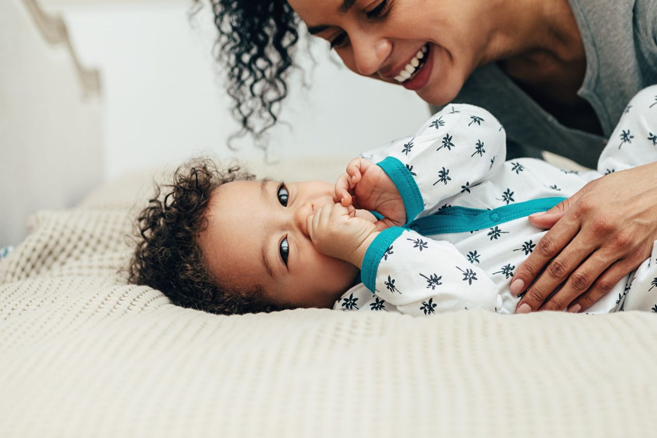 mother with toddler on bed