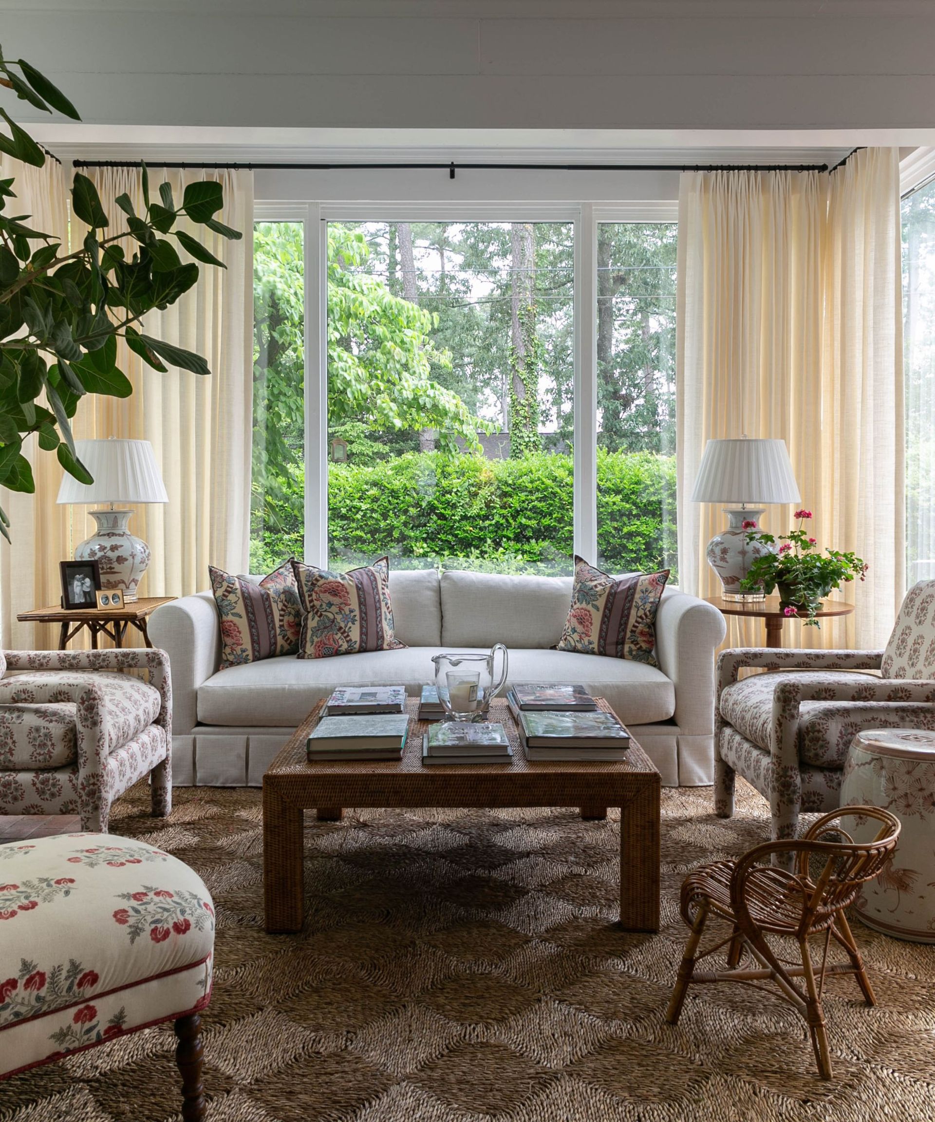 carley summers sunroom with upholstered cozy seating and a large rattan rug