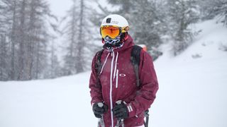 Man wearing ski jacket, goggles, and helmet