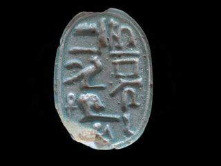 A photo showing the hieroglyphic inscription on the scarab.