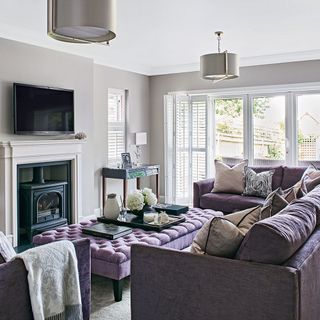 living room with purple sofa set and fireplace