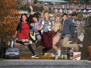 The Derry Girls jumping for joy.