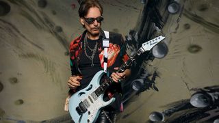 Steve Vai with his signature Ibanez PIA with matching DiMarzio Blue Powder UtoPIA humbuckers