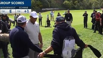 Tiger Woods talks to a fan after his ball lands in his jacket at the Genesis Invitational