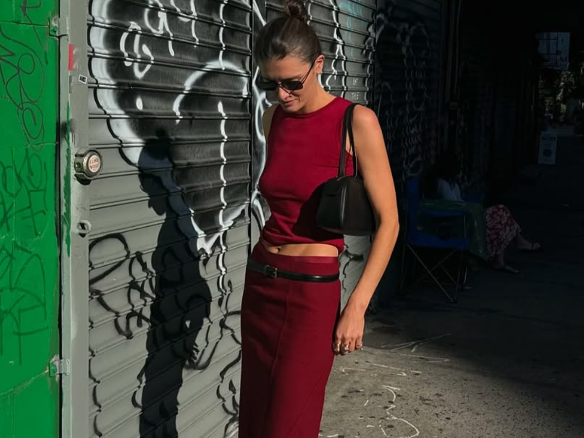 woman wearing matching red set with black boots in nyc summer outfit