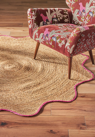 round jute rug with a pink scalloped border