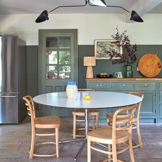 dining room with circular Italian midcentury table and birch dining chairs