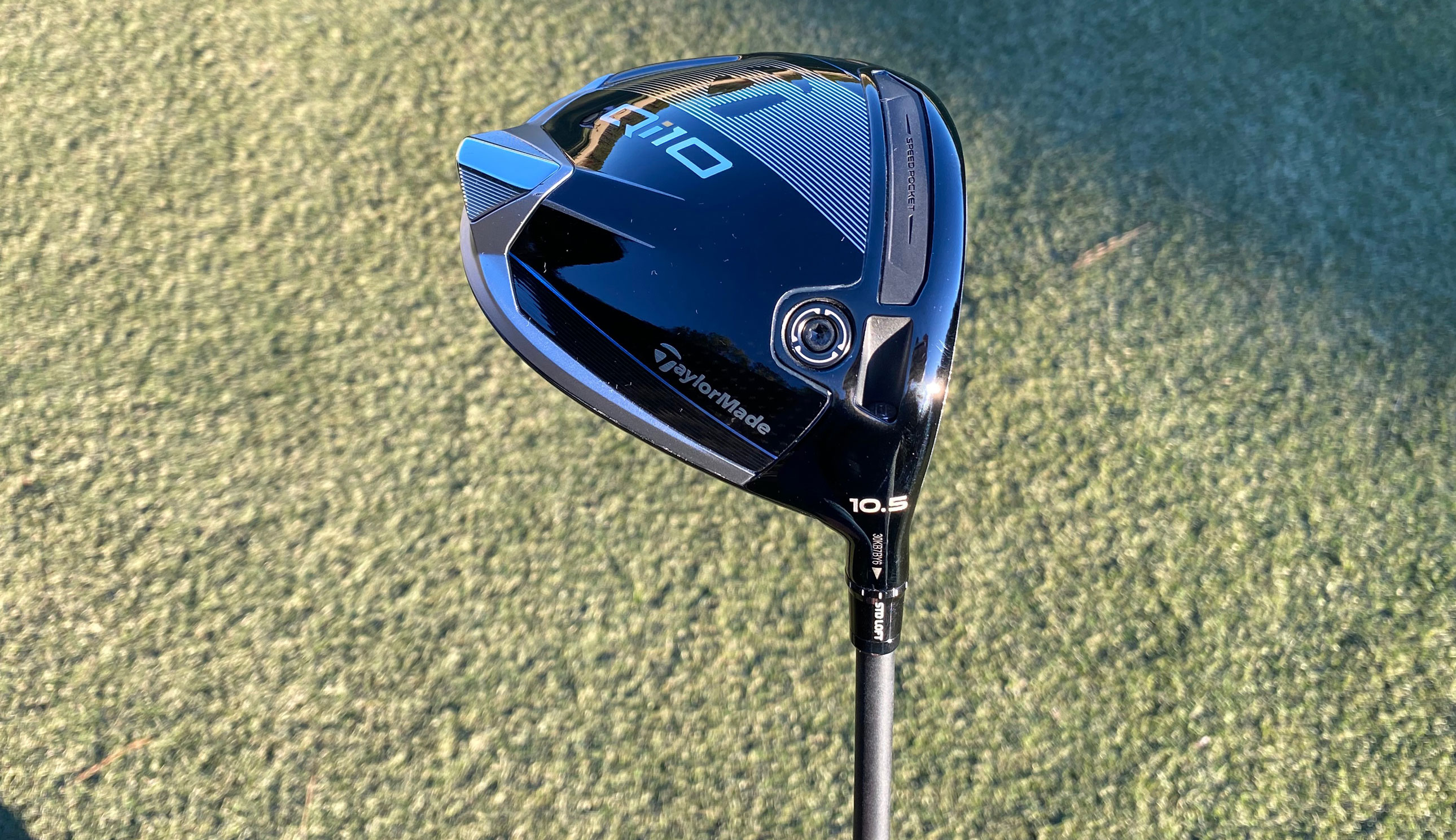 The TaylorMade Qi10 Driver on a green background