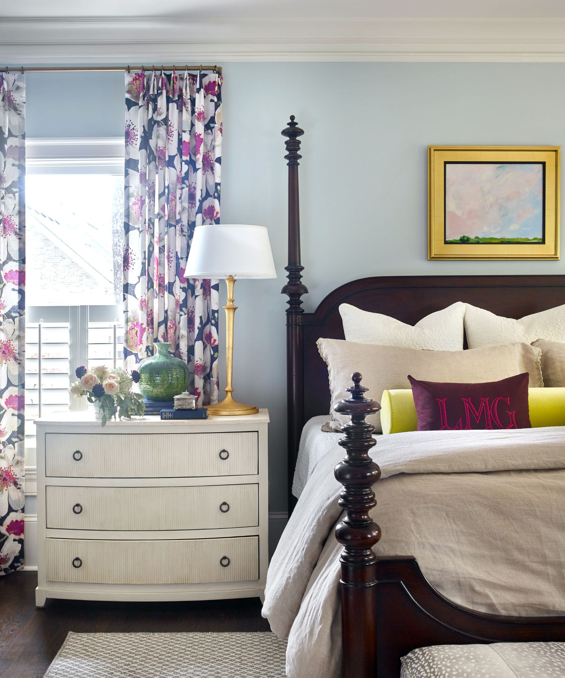 bedroom with pale blue walls and wooden bedframe