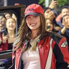 Hailey Bieber wearing a red baseball cap