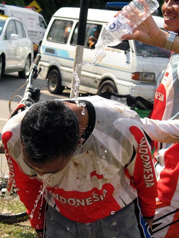 Elite men's downhill champion Popo Ario Sejati (Indonesia) gets splashed by his teammates.