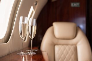 Interior of plane with champagne glasses for trip