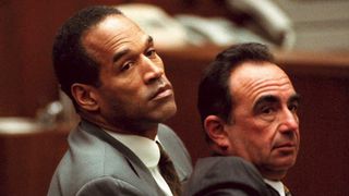LOS ANGELES, CA - JANUARY 4:O.J.Simpson (L) looks over the shoulder of his head defense attorney, Robert Shapiro, 04 January during a hearing in which Simpson waived his right to challenge th