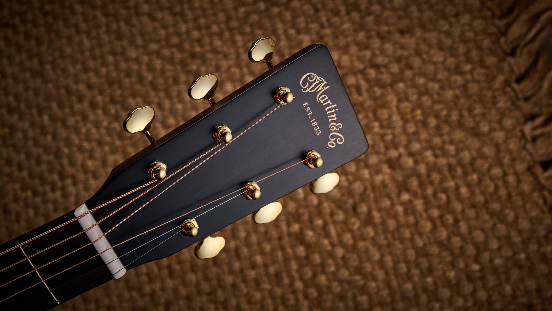 Martin GPE Inception Maple photographed against a wheat coloured woven rug.
