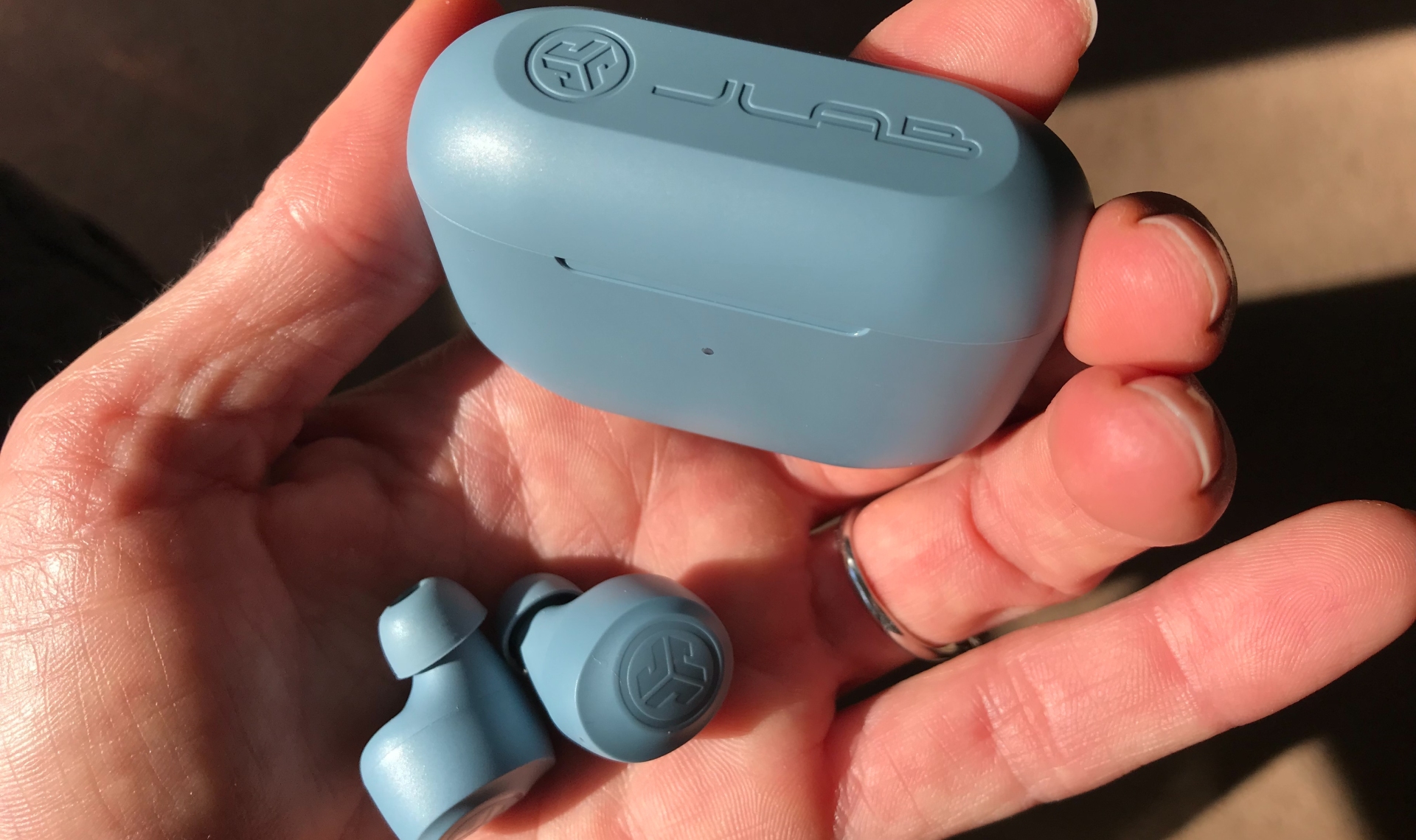 JLab Go Air Pop earbuds and case in a hand