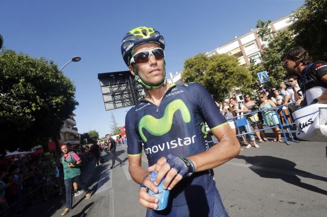A Movistar rider get s drink after another hot day of racing