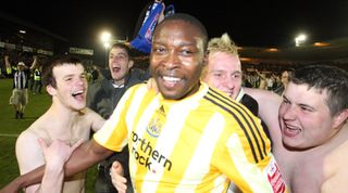 PLYMOUTH, UNITED KINGDOM - APRIL 19:Shola Ameobi celebrates with fans after the Coca Cola Championship match between Plymouth Argyle and Newcastle United at the Home Park on April 19, 2010 in Plymouth, England. (Photo by Ian Horrocks/Newcastle United via Getty Images)
