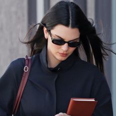 Kendall Jenner wore the high-vamp flats trend and straight-leg jeans with a burgundy and navy color combination