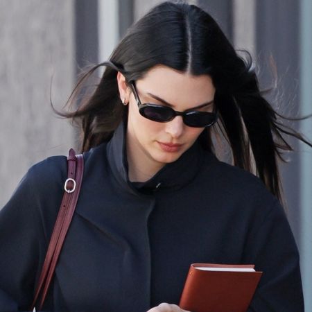 Kendall Jenner wore the high-vamp flats trend and straight-leg jeans with a burgundy and navy color combination