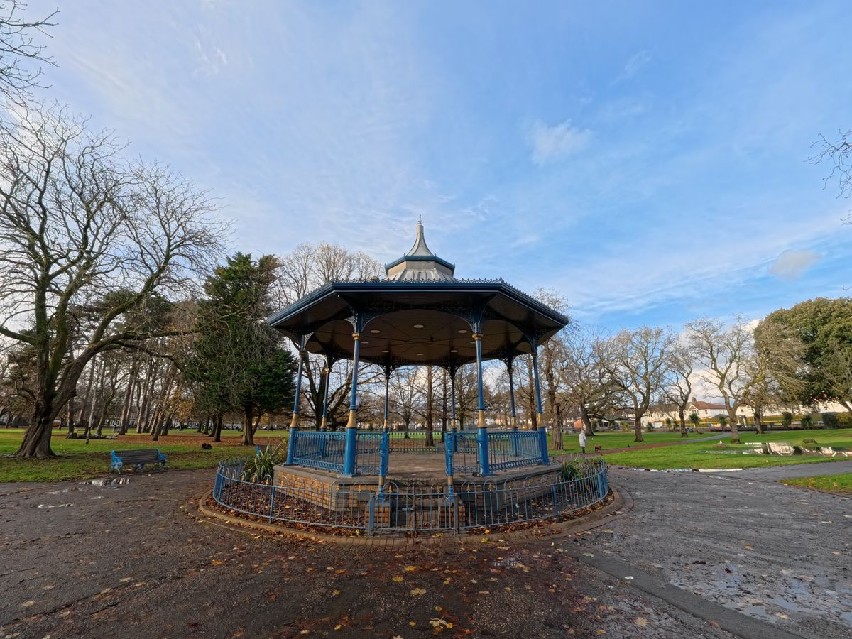 A photo of a pavilion in a park with trees and a blue sky in the background. Shot on the Insta360 Ace Pro in Dewarp FoV.