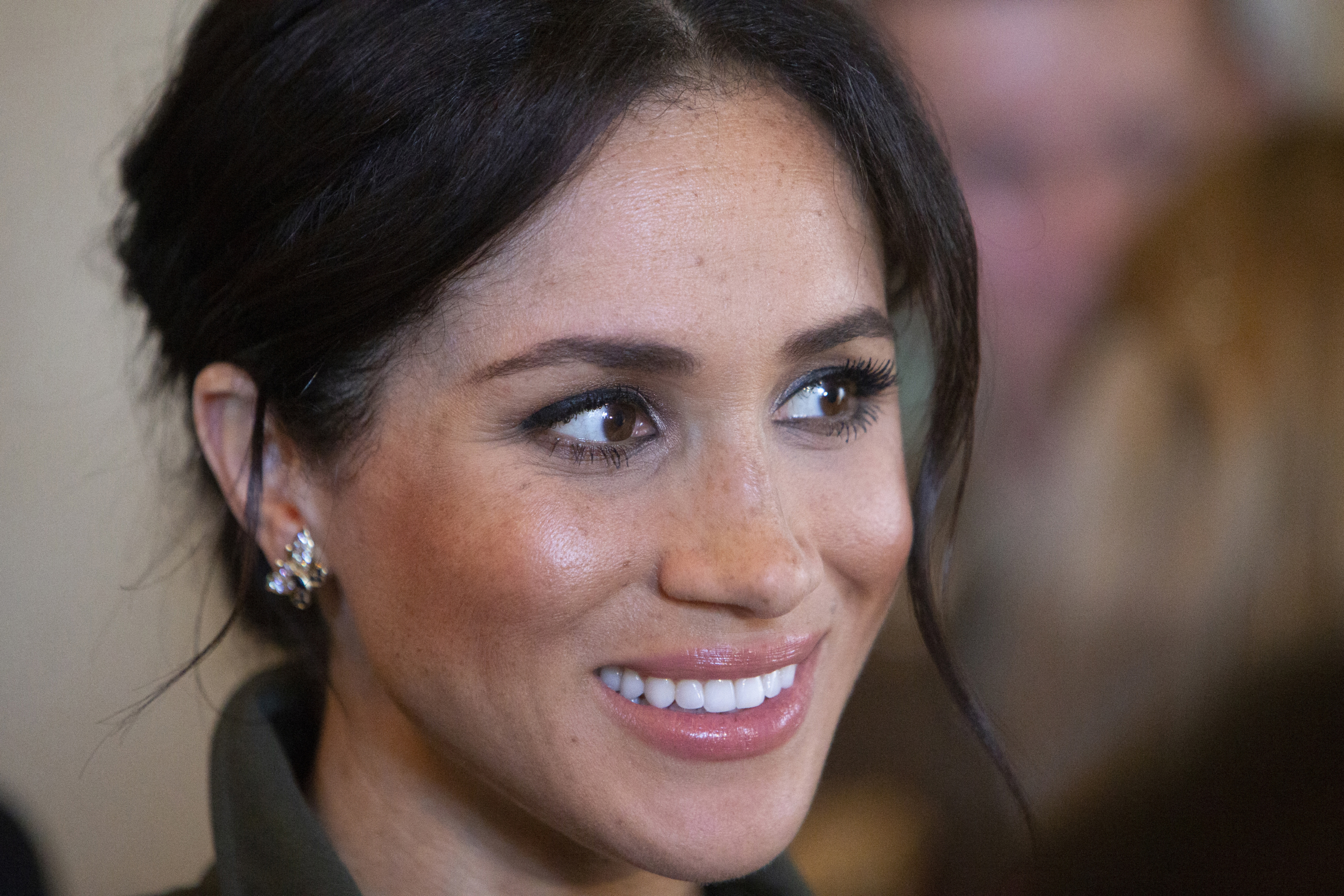 Meghan Markle smiling wearing butterfly earrings