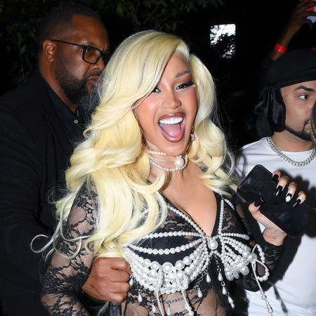 a latina woman with long, platinum blonde hair laughing mid photo