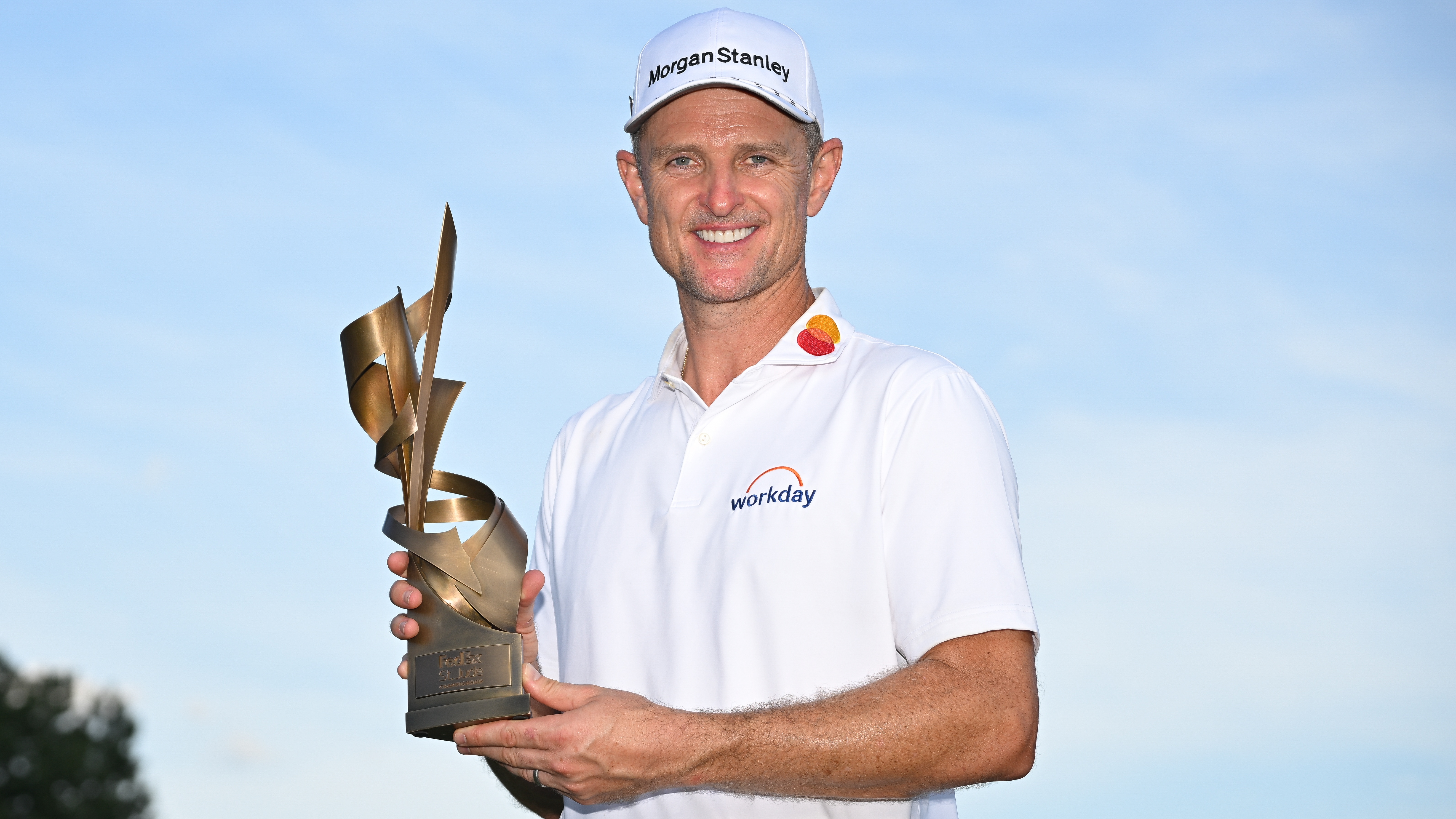 Justin Rose of England holds the trophy on the 18th green after the final round of FedEx St. Jude Championship at TPC Southwind on August 10, 2025 in Memphis, Tennessee