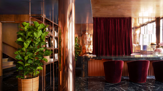 A shot of the reception at Hotel Villa Marquis, completed with rose gold design details and red velvet furnishings