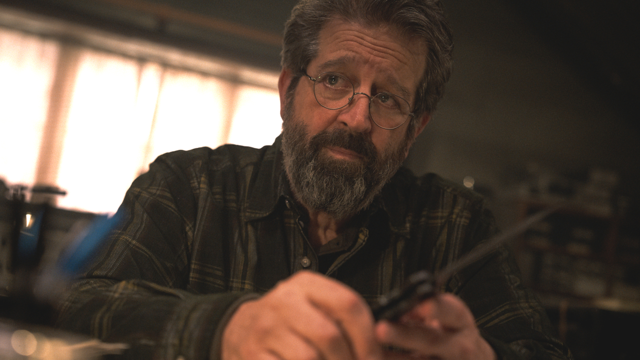 Rolf Saxon sits with a worried expression while holding a knife in Mission: Impossible - The Final Reckoning.