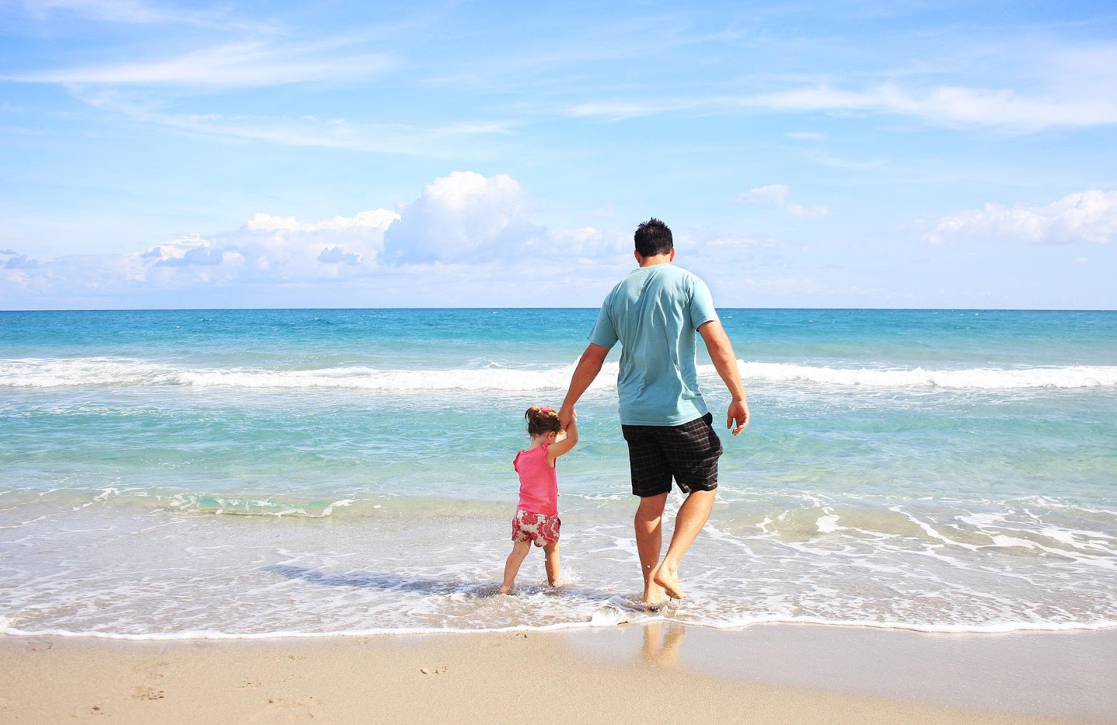 Father and Daughter playing on the beach