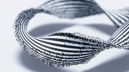 A twisted black and white striped ribbon is covered with small black and white dots against a white background