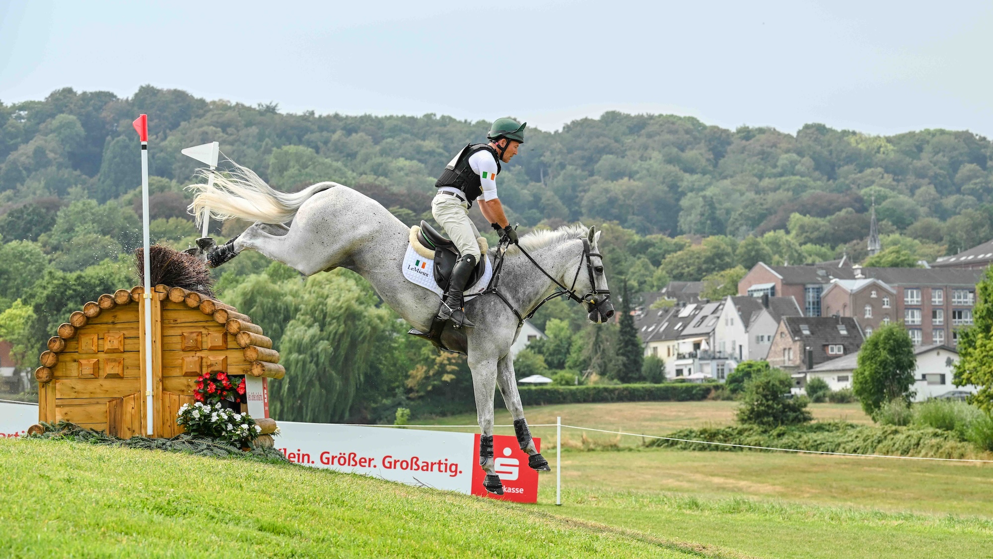 Austin O'Connor and Colorado Blue jump rolltop fence on Aachen World Championships cross-country course for Ireland