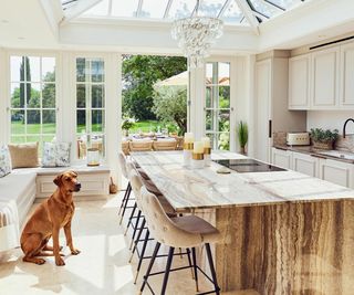 cream orangery kitchen conservatory with dog sat near kitchen island