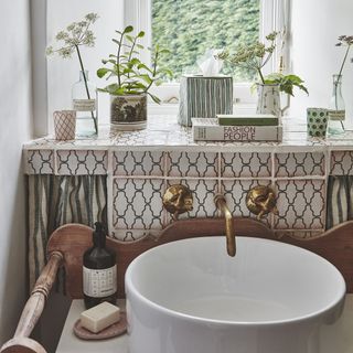 Bathroom with white sink and curtain behind it