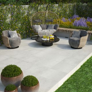 patio area with light coloured paving slabs