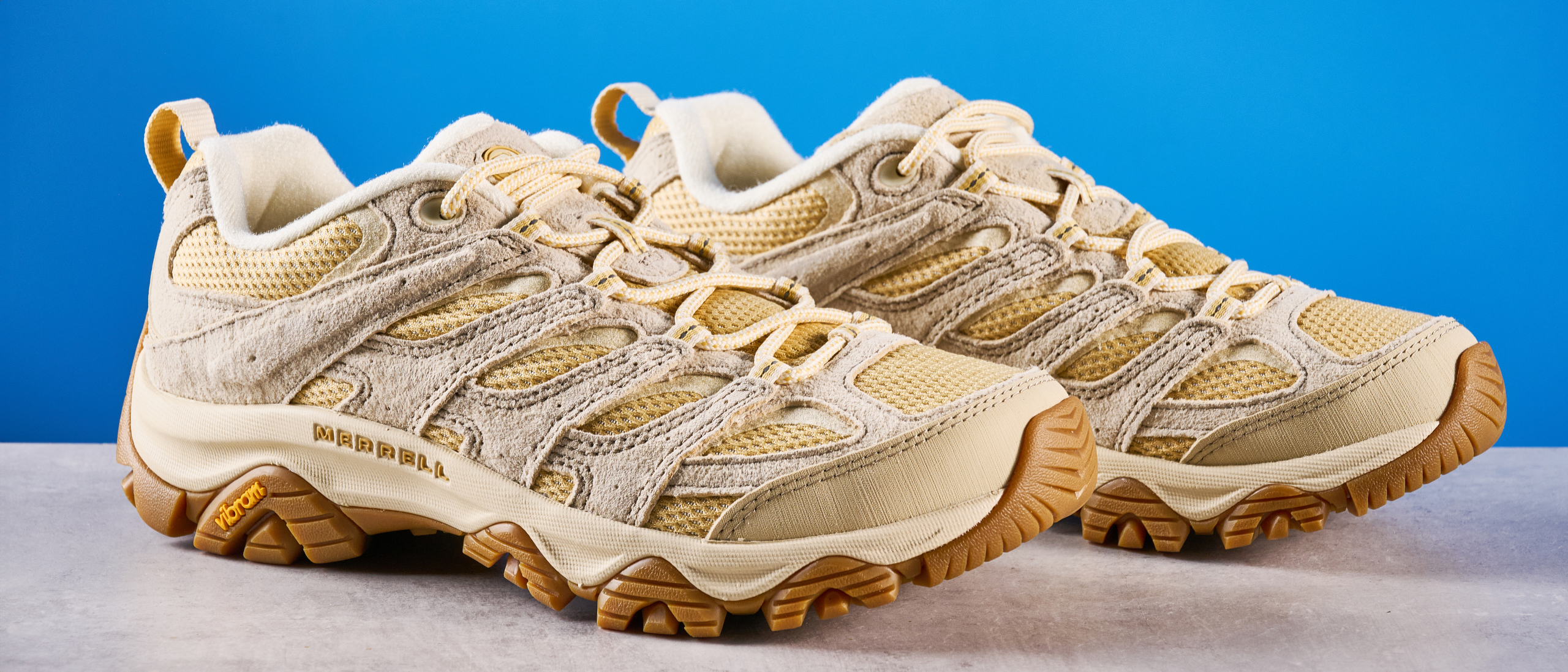 the merrell moab 3 photographed against a blue tom's guide background