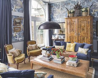 Living room ceiling light ideas with a black metal lampshade hanging low over seating area in a traditional blue and yellow room