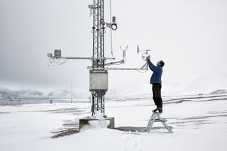 An image from series that won the 2019 award, of a researcher working with tools for measuring climate data