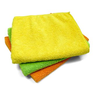 A stack of three microfiber cloths in orange, green and yellow