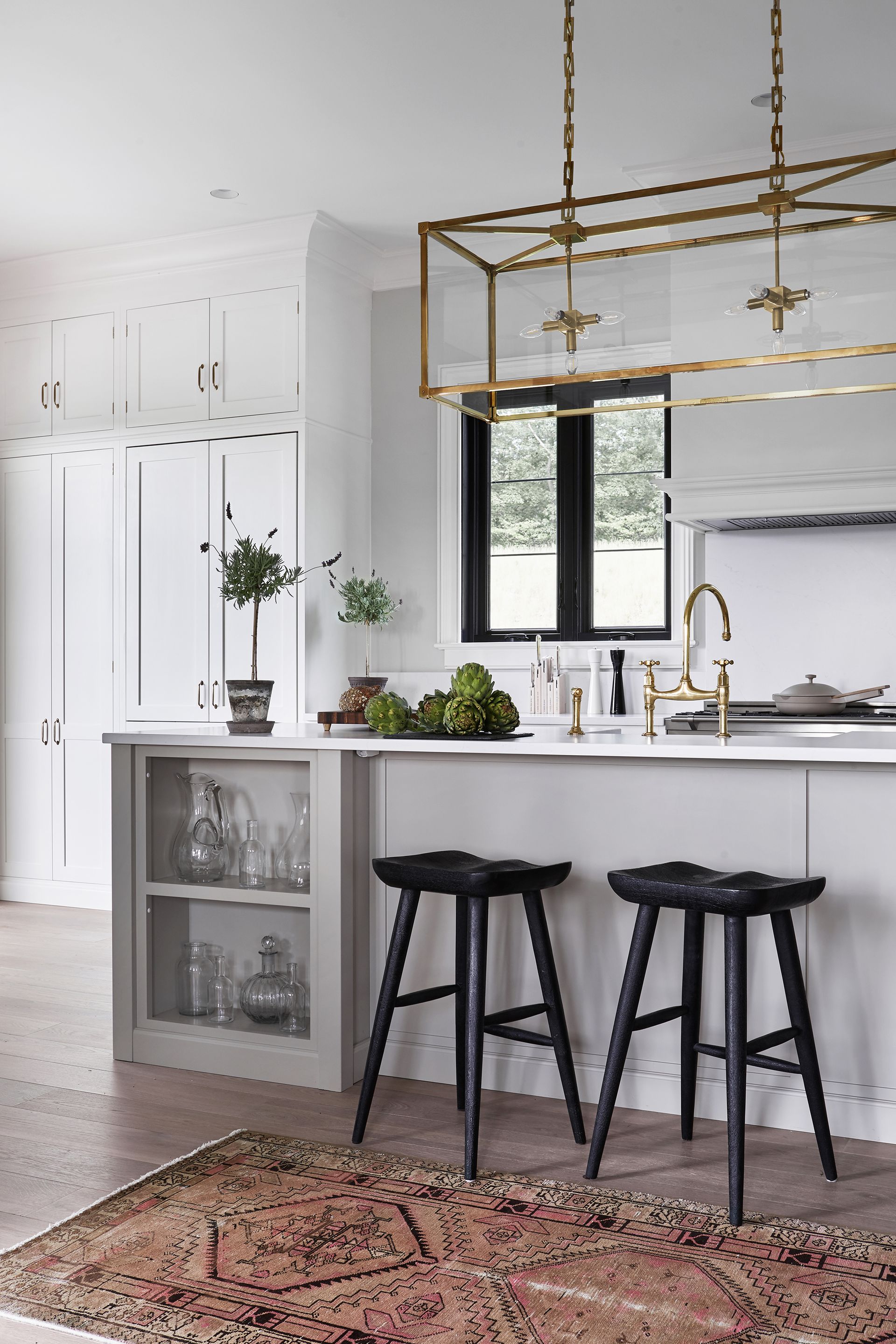 kitchen with turkish rug modern cabientry black seating and statement pendant light