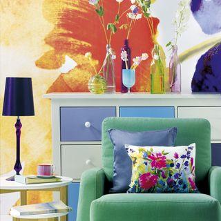 living room with mural and green armchair