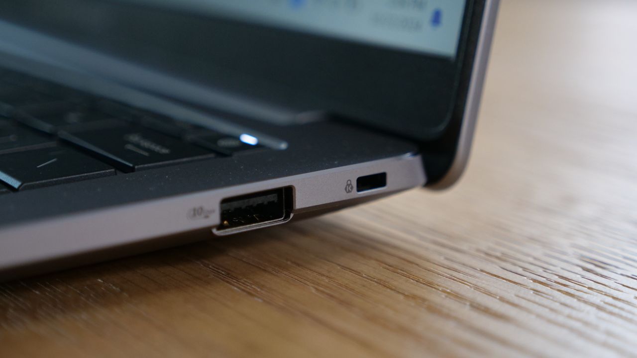 Sideview of Asus ExpertBook P5 (P5405) open on a wooden table focused on its ports